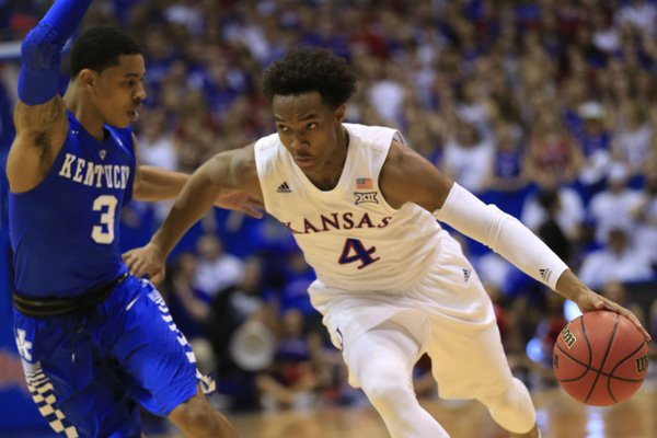 Kansas guard Devonte' Graham (4) and Kentucky guard Tyler Ulis (3) during the first half of an NCAA college basketball game in Lawrence, Kan., Saturday, Jan. 30, 2016. (AP Photo/Orlin Wagner)