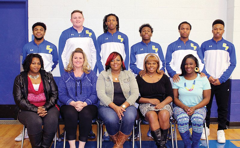 Six current members of the Guy-Perkins Thunderbirds basketball team have mothers who also played for longtime coach John Hutchcraft. The mothers include, seated, from left, April Givan, Charlotte (Hutchcraft) Sober, Krissy Ealy, Demetris McVay and Jessie McVay. Not pictured is Barbara Pledger Manuel. The players are, standing, from left, Kamair McKnight, Wyatt Spires, Jachoree Ealy, Timothy Campbell, Tre Minton and Ambrose Rodriguez.