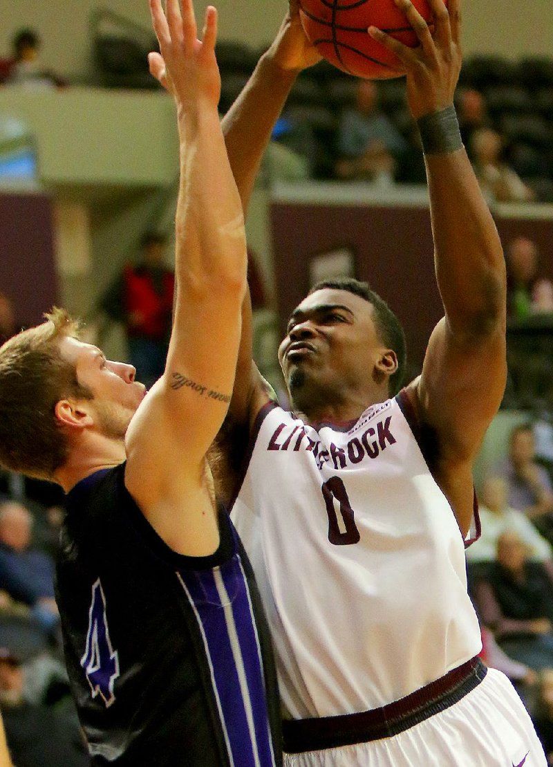 Roger Woods (right) has continued to contribute on both ends of the court since returning to UALR’s starting lineup.