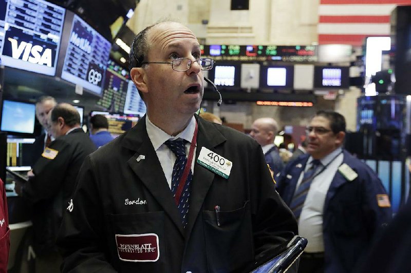 Trader Gordon Charlop works Wednesday on the floor of the New York Stock Exchange. It was a seesaw day for traders. 