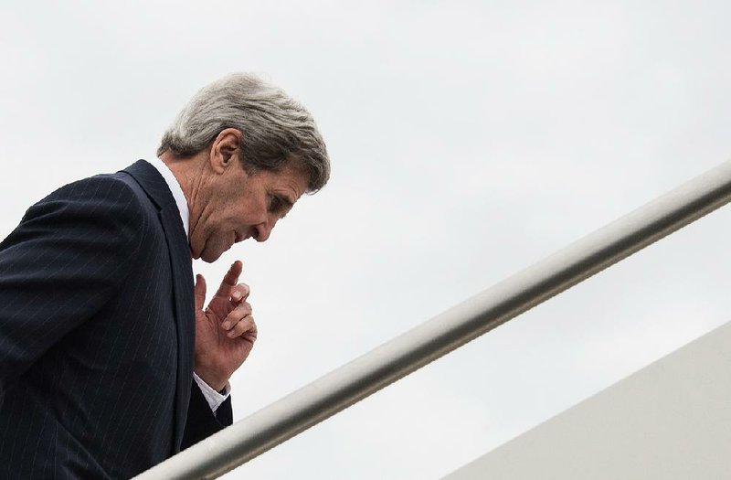 U.S. Secretary of State John Kerry boards his plane Wednesday in Rome, heading to London to meet with allies about Syria. 