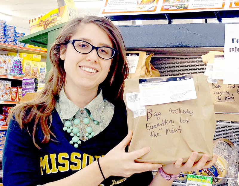 RITA GREENE MCDONALD COUNTY PRESS Eden Stewart, nutrition educator from the University of Missouri Extension office, showing a grab-and-go dinner filled with healthy foods. She prepared the meal in the bag. The grab-and-go dinners can be purchased at Town and Country grocery in Anderson.