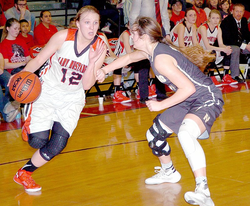 Photo by Rick Peck McDonald County&#8217;s Baili Nelson drives past a Neosho defender during the Lady Wildcats&#8217; 48-26 win Friday night at MCHS.