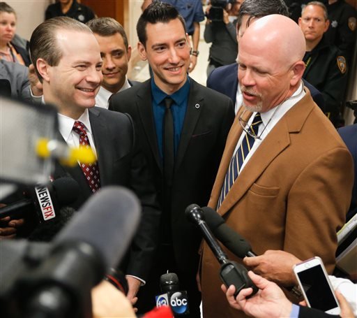 David Daleiden, center, one of the two anti-abortion activists indicted last week, addresses the media with attorney's Jared Woodfill, left, and Terry Yates after surrendering to authorities Thursday, Feb. 4, 2016, in Houston.