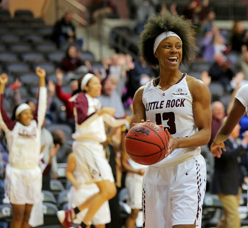 UALR junior guard Sharde Collins is all smiles Thursday after the Trojans outscored Troy 27-10 in the third quarter to take a 55-50 lead. Collins and Shanity James scored 18 points each as UALR defeated Troy 79-64 at the Jack Stephens Center in Little Rock.