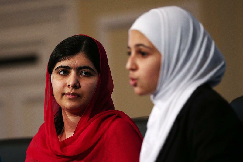 Nobel Peace Prize winner Malala Yousafzai, 18, (left) and 17-year-old Syrian refugee Mezon al-Melihan appear Thursday at a donor conference in London to push for $1.4 billion in education aid for children in Syria and refugee camps.