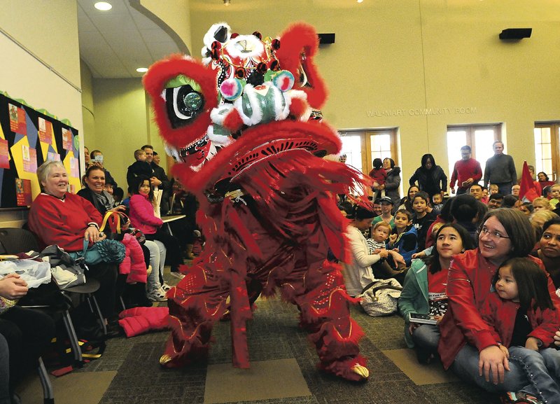 File Photo Flip Putthoff A Chinese new year lion dances its way around a crowd at the Bentonville Public Library. The library&#8217;s seventh annual Chinese New Year celebration is Saturday.