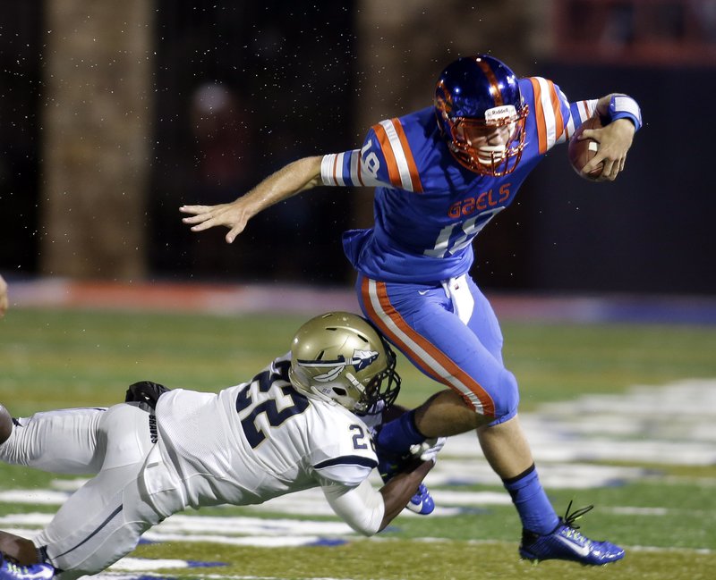 Bishop Gorman quarterback Tate Martell is tackled by St. John Bosco's Clifford Simms during the first half of a high school football game in Las Vegas. Martell, the nation's No. 2 junior quarterback according to the 247Sports Composite, has verbally committed to Texas A&M. 