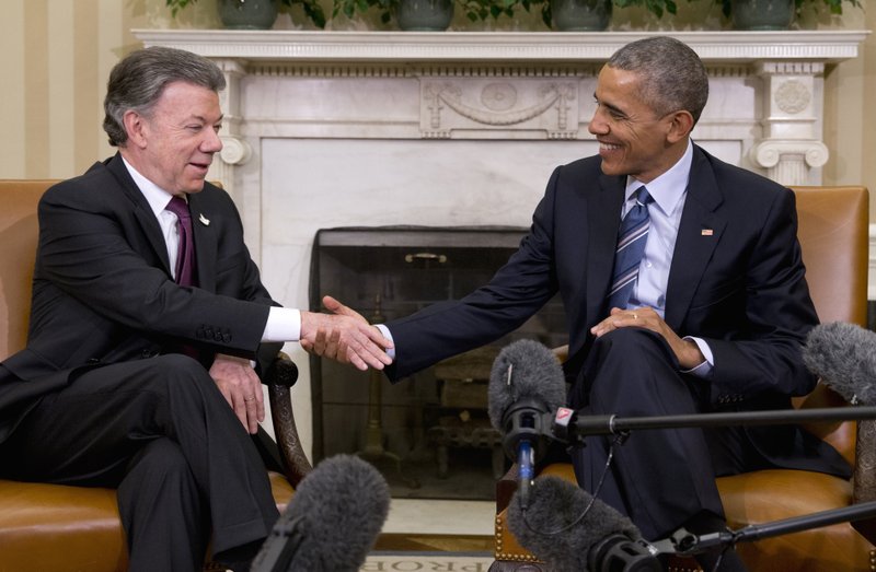 President Barack Obama shakes hands with Colombian President Juan Manuel Santos during their meeting in the Oval Office of the White House in Washington, Thursday, Feb. 4, 2016. (AP Photo/Carolyn Kaster)