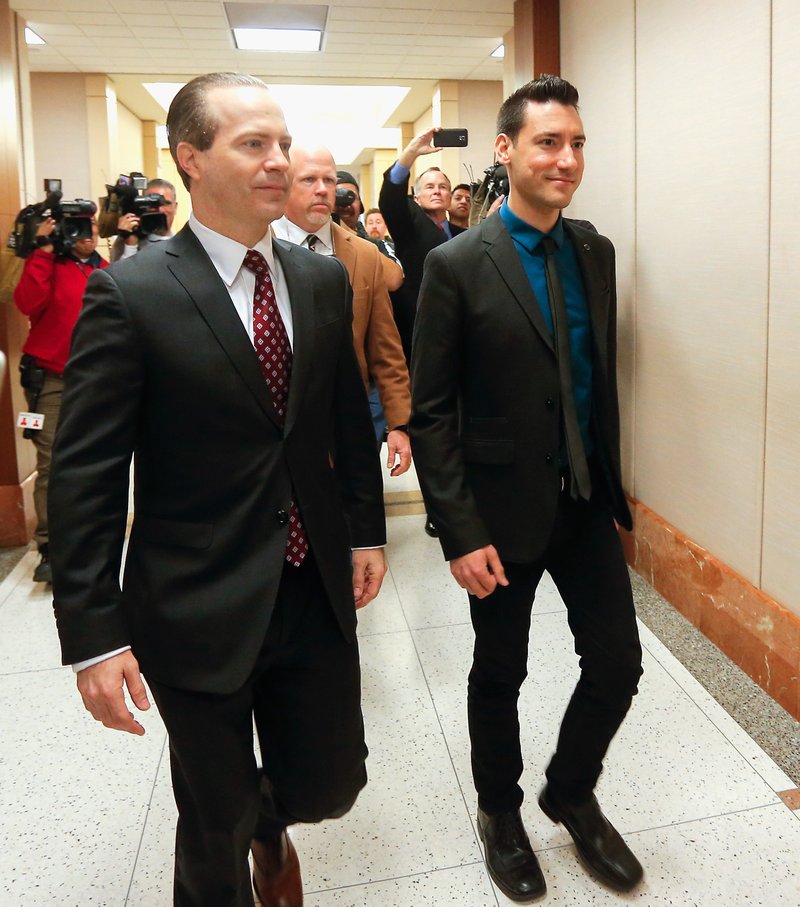 David Daleiden, right, one of the two anti-abortion activists indicted last week, arrives with attorney Jared Woodfill for court after turning himself in to authorities Thursday, Feb. 4, 2016, in Houston. Daleiden and Sandra Merritt are charged with tampering with a governmental record, a felony punishable by up to 20 years in prison. 