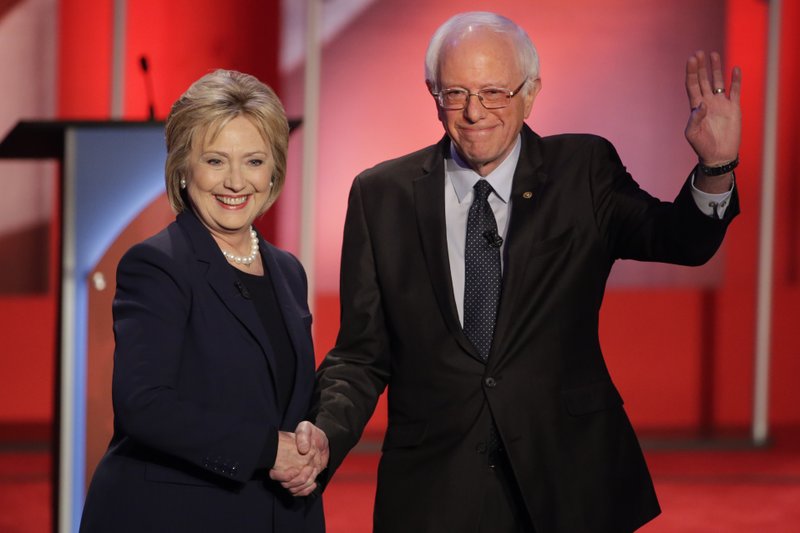 Hillary Clinton and Bernie Sanders greet the audience Thursday evening before squaring off in a Democratic presidential primary debate hosted by MSNBC in Durham, N.H.