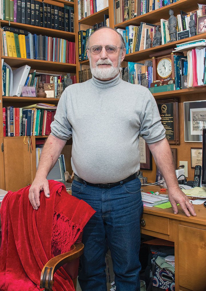 David Larson stands in the downstairs library of his home in Conway. Larson, 73, is a retired Hendrix College history professor and has served as the pronouncer for the Faulkner County Spelling Bee for more than three decades. He also just finished writing a history of his hometown, Park River, North Dakota, and is looking for a publisher.