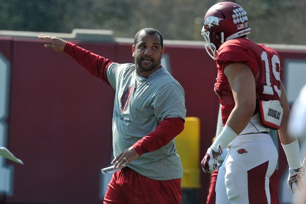 Arkansas running backs coach Jemal Singleton works with his team during practice Tuesday, March 31, 2015, in Fayetteville.