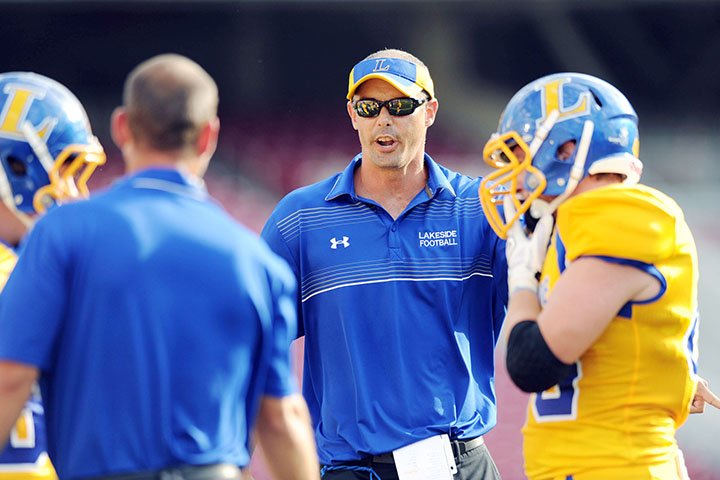 Hot Springs Lakeside coach Jared McBride speaks to his team in a game against the Lincoln Wolfpack during the first half of play Sept. 1, 2014, at Razorback Stadium in Fayetteville.