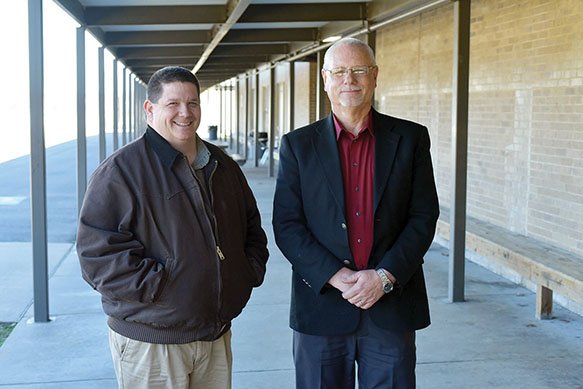 Perryville High School Principal Kevin Campbell, left, and Perryville School District Superintendent Ron Wilson stand near the 56-year-old high school cafeteria. The Arkansas Department of Education has approved the district tearing down the structure, but school officials said a small property-tax increase would be needed to replace the cafeteria.