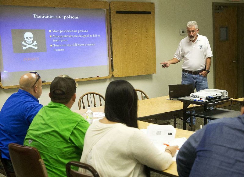 Gene McAvoy (right), a Florida county extension director, speaks to students last year during a state pesticide safety training class for farm supervisors in Sebring, Fla. 