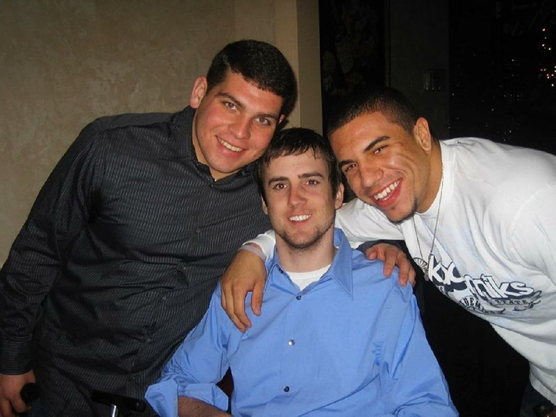 Tyson Gentry (center) poses with friends Matt Daniels (left) and Kurt Coleman in January 2008, the day before Ohio State’s national championship game against LSU. Coleman, who now plays for the Carolina Panthers, has formed a unique bond with Gentry, a former Buckeyes wide receiver who was paralyzed from the neck down following a hit from Coleman in April of 2006. 