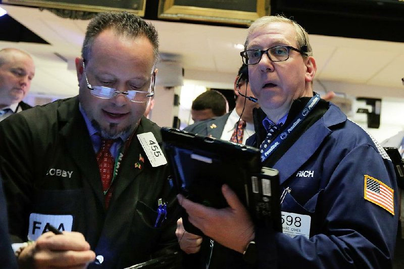 Traders Robert Arciero (left) and Richard Cohen work Friday on the floor of the New York Stock Exchange. 