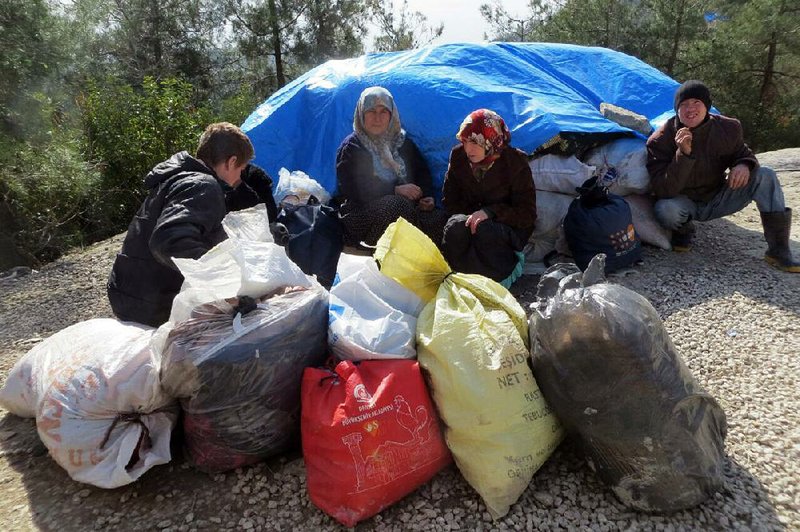 Syrian civilians wait Friday at the Bab al-Salam border gate, hoping to cross into Turkey to escape intense fighting in the north of their country.