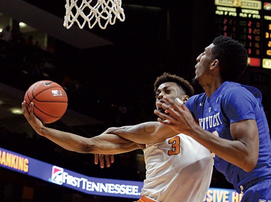 The Associated Press VOL CALL: Tennessee guard Robert Hubbs III (3) draws a foul from Kentucky forward Alex Poythress in the second half of the Volunteers' 84-77 upset of the visiting Wildcats Tuesday night. Arkansas plays Tennessee tonight at Walton Arena in Fayetteville, both 11-11 overall and 4-5 in the Southeastern Conference. Tip-off is 7 p.m