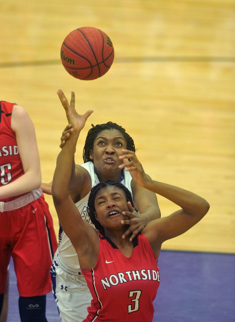 Fayetteville High’s Jasmine Franklin (behind) and Fort Smith Northside’s Topaz Hawkins (3) fight for a rebound Friday during their game at Fayetteville High School.