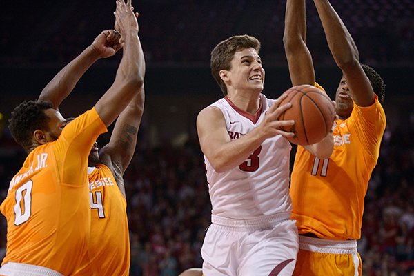 Dusty Hannahs of Arkansas drives to the basket as Kevin Punter, Jr. (0), Armani Moore (4) and Kyle Alexander (11) of Tennessee defend on Saturday Feb. 6, 2016, during the game in Bud Walton Arena in Fayetteville.