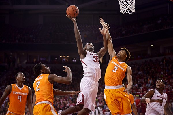 Moses Kingsley of Arkansas takes a shot as Robert Hubbs III of Tennessee tries to block on Saturday, Feb. 6, 2016, during the game in Bud Walton Arena in Fayetteville.
