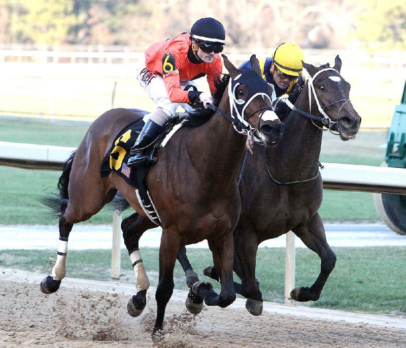 Channing Hill rides Marquee Miss (left) across the wire to beat Nickname (right) in the Martha Washington Stakes at Oaklawn Park on Saturday. 