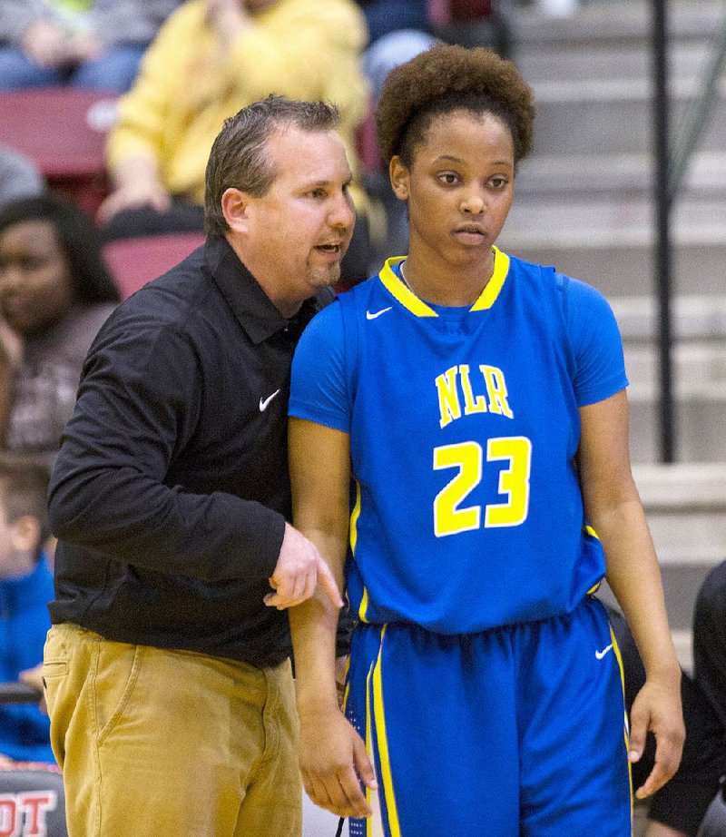 North Little Rock Coach Daryl Fimple talks to Kyra Collier during a game Friday against Cabot. Collier was in a car accident last month, but it didn’t faze the senior guard, who scored a career-high 33 points less than 24 hours later. 