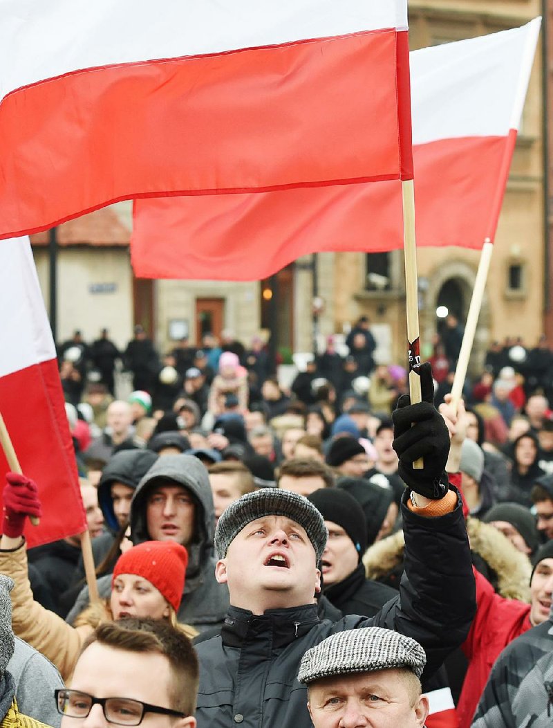 Protesters wave Polish flags during an anti-immigration rally Saturday in Warsaw.