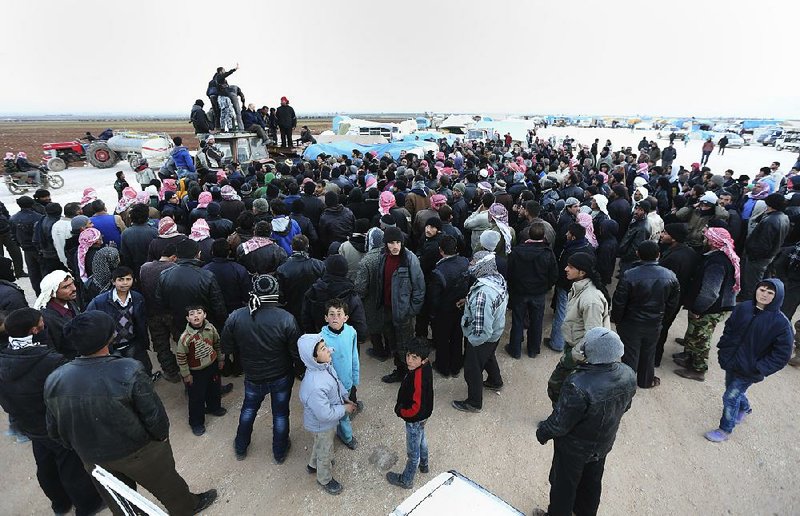 Syrians gather Saturday at the Bab al-Salam gate on the Syria-Turkey border.