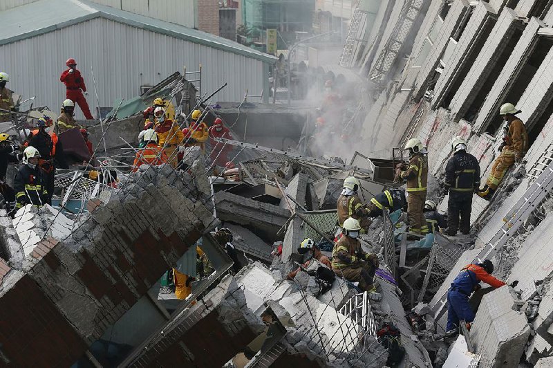 Rescue teams search Saturday in the debris of a building that collapsed during an earthquake in Tainan, Taiwan.