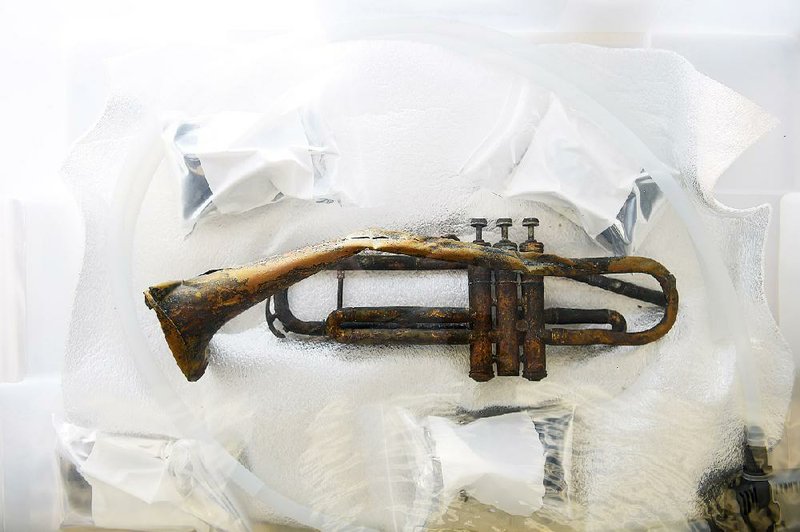 The battered trumpet salvaged in 2013 from the wreckage of the USS Houston in the Flores Sea north of Australia now sits in the conservation lab at the Washington Navy Yard.