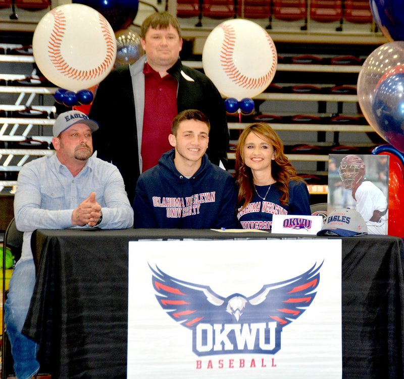 Graham Thomas/Siloam Sunday Siloam Springs senior Dodge Pruitt signed a letter of intent to play baseball at Oklahoma Wesleyan on Wednesday. Pictured, from left, are Hoppy Free, Dodge Pruitt, Shawna Free and, standing, head baseball coach Alan Hardcastle.