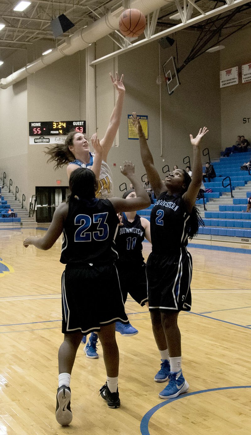 Photo courtesy of JBU Sports Information John Brown freshman Baily Cameron goes up for a shot during Thursday&#8217;s game against Southwestern Christian (Okla.). The Siloam Springs native scored 24 points and grabbed 12 rebounds in the Golden Eagles&#8217; 66-58 victory.