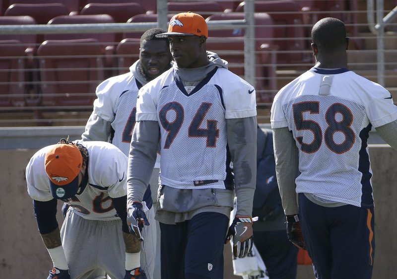 Denver Broncos defensive end DeMarcus Ware (94) and teammates wait during a drill at an NFL football practice in Stanford, Calif., Friday, Feb. 5, 2016.