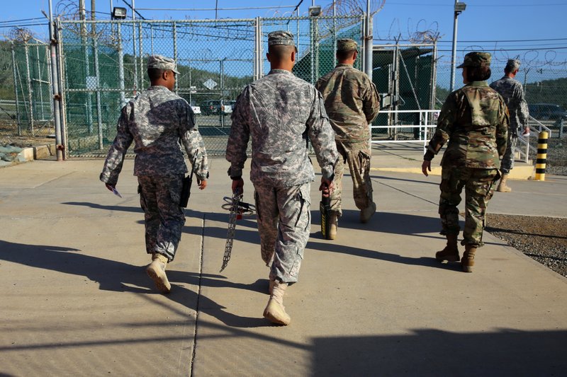 Military guards at the Guantanamo Bay detention center in Cuba on Tuesday exit Camp Delta, an area that once held hundreds of prisoners but is now used mostly for administrative offices.
