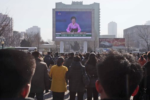 North Koreans watch an electronic screen announcing the launch of a satellite on Sunday, Feb. 7, 2016, at the Pyongyang Railway Station in Pyongyang, North Korea. 