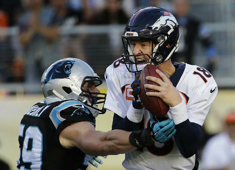 Denver Broncos quarterback Peyton Manning (right) is sacked by Carolina Panthers lineback Luke Kuechly (59) during the first half Sunday in Santa Clara, Calif.