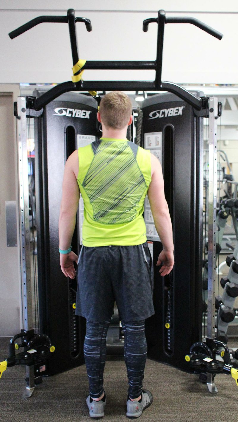 J.D. Stephenson does step 1 of the Quarter Pull-ups exercise on a cable machine at Little Rock Racquet Club.