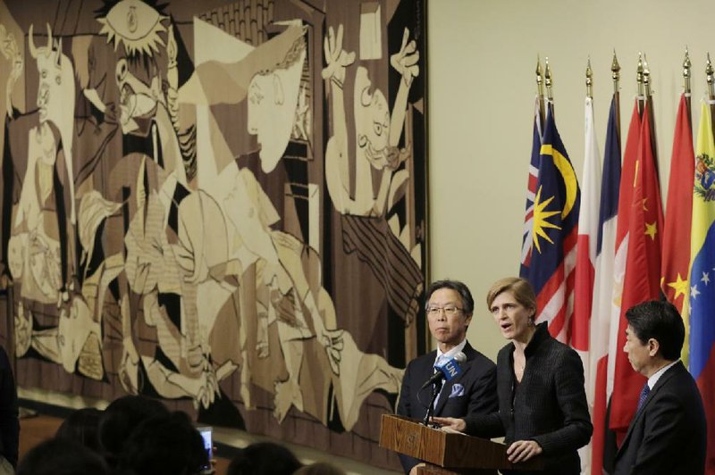 Motohide Yoshikawa, left, Japan's ambassador to the United Nations, and South Korea's Ambassador Oh Joon listen as Samantha Power, center, the U.S. ambassador, makes comments to the media following a Security Council meeting at U.N. headquarters, Sunday, Feb. 7, 2016. 