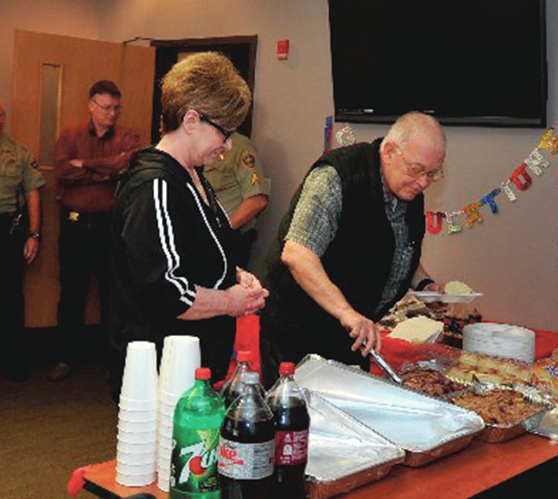 The Sentinel-Record/Mara Kuhn O.A. Wynn, sex offender registrar, and Judy Wynn, his wife, celebrated Wynn's retirement recently after 20 years of service at the Garland County Sheriff's Department.