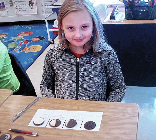 Submitted photo Brailey Golden, a second-grade student at Lake Hamilton Elementary School, displays the Oreo cookies she used to demonstrate the phases of the moon. Students in Shari Misener's class learned about the phases of the moon and the cookies were used to demonstrate how the moon changes from a new moon to a full moon each month.