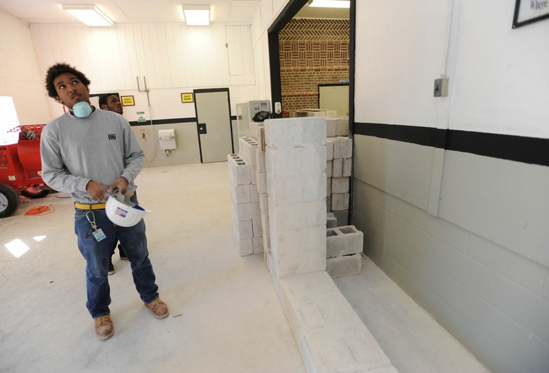 Aaron Young of Arlington, Texas, gives a tour Tuesday of the bricklaying classroom at the Cass Job Corps in Ozark.