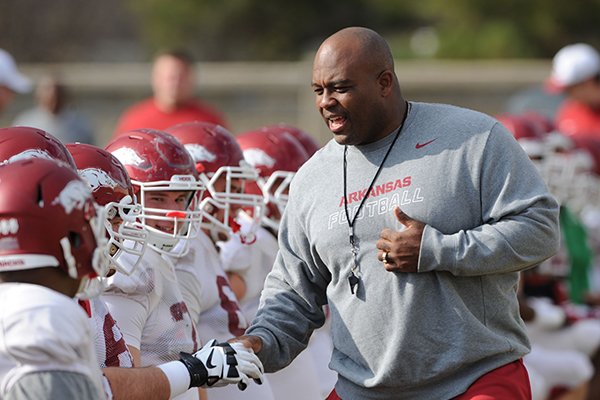Arkansas assistant coach Clay Jennings speaks to players during practice Saturday, Dec. 13, 2014, at the university's practice facility in Fayetteville.