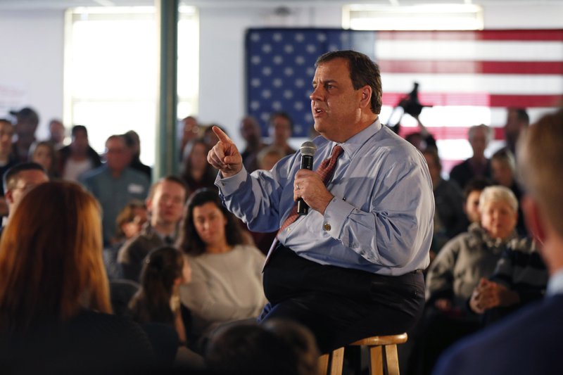 Supporters listen as Republican presidential candidate New Jersey Gov. Chris Christie speaks at a town hall-style campaign event Sunday at Hampton Academy in Hampton, N.H. 