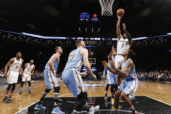 Denver Nuggets defenders, including Nuggets forward Danilo Gallinari (8), Nuggets center Jusuf Nurkic (23) and others defend Brooklyn Nets forward Joe Johnson (7) in the first half of an NBA basketball game, Monday, Feb. 8, 2016, in New York. The Nets defeated the Nuggets 105-104 on Johnson's three-point buzzer beater. (AP Photo/Kathy Willens)