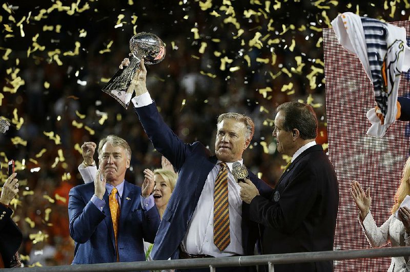 John Elway, General Manager and Executive Vice President of Football Operations for the Denver Broncos holds the championship trophy after the NFL Super Bowl 50 football game Carolina Panthers Sunday, Feb. 7, 2016, in Santa Clara, Calif. The Broncos won 24-10. 