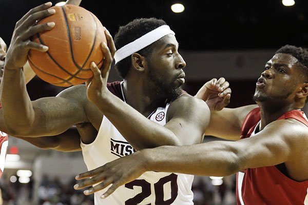 Mississippi State forward Gavin Ware (20) tries to pass the ball past Arkansas forward Trey Thompson (1) in the first half of an NCAA college basketball game in Starkville, Miss., Tuesday, Feb. 9, 2016. (AP Photo/Rogelio V. Solis)
