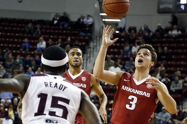 Arkansas guard Dusty Hannahs (3) loses control of the dribble against the defense of Mississippi State guard I.J. Ready (15) in the first half of an NCAA college basketball game in Starkville, Miss., Tuesday, Feb. 9, 2016. (AP Photo/Rogelio V. Solis)
